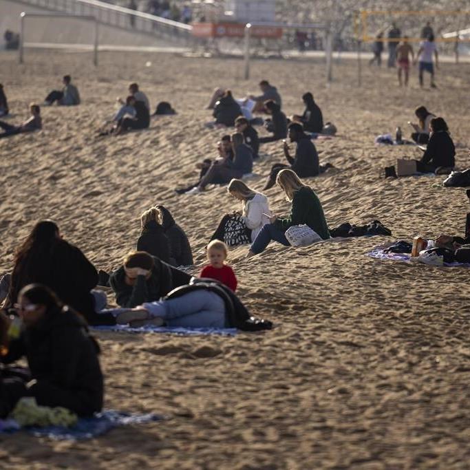 People take to the beach as a winter heat wave hits much of Spain